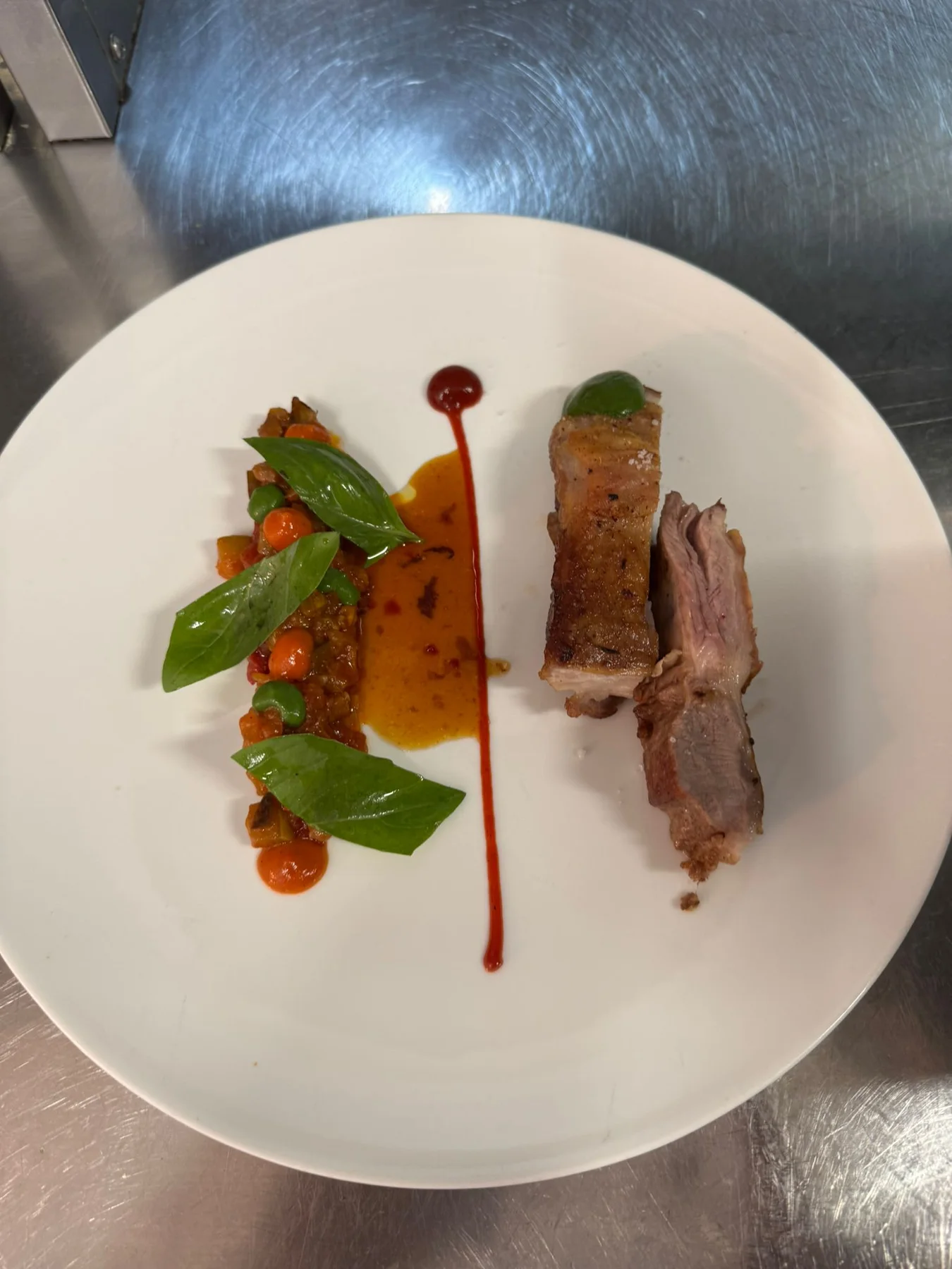 Lamb saddle, ratatouille, pepper and basil cream, lamb jus, fresh basil.